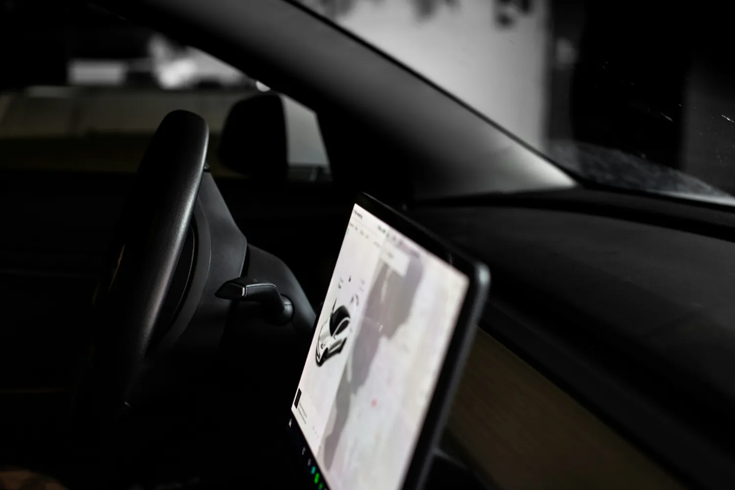 Vehicle cabin with steering wheel and central dashboard screen