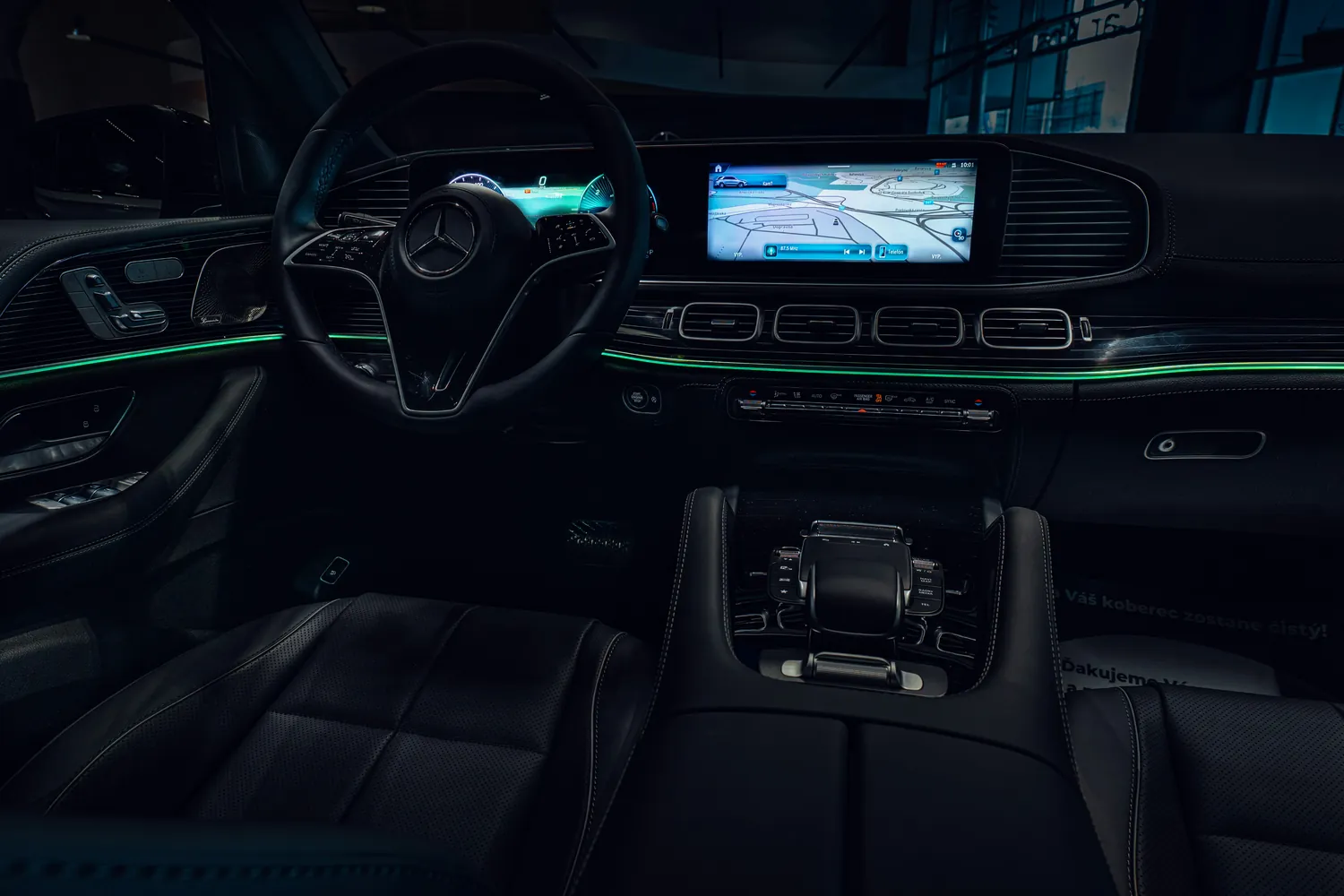 Dark modern vehicle interior with illuminated dashboard displays